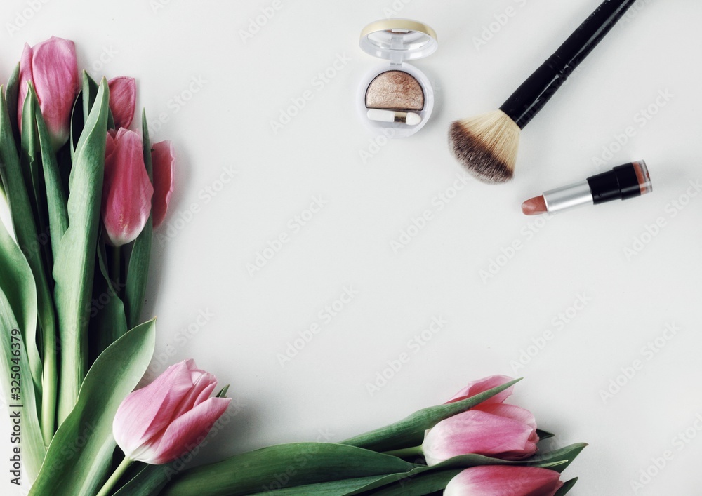 Beautiful spring flowers bouquet with cosmetics for greetings isolated on white