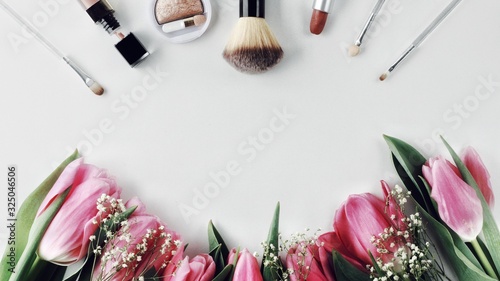 Obraz na płótnie Beautiful spring flowers bouquet with cosmetics for greetings isolated on white w salonie
