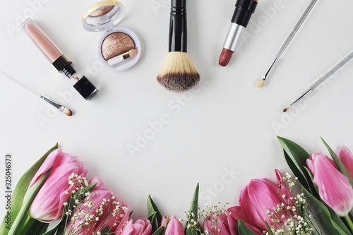 Obraz na płótnie Beautiful spring flowers bouquet with cosmetics for greetings isolated on white w salonie