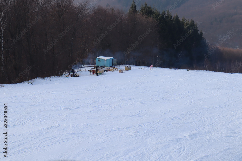 people enjoy outdoor activities in the mountains, skiing and snowboarding