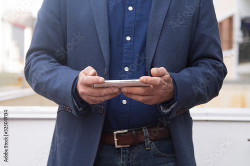 man using mobile phone close-up view