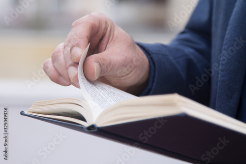 man reading a book close up view