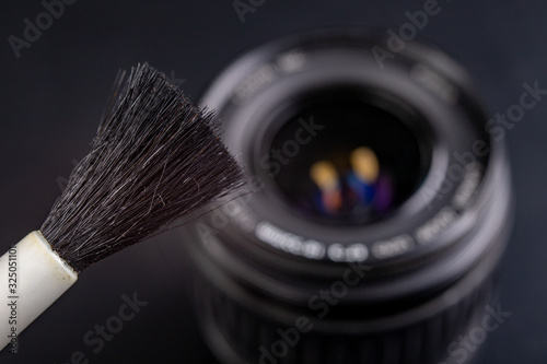 Cleaning the photographic lens. Removing dust and dirt from photo accessories.