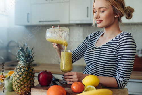 Happy smiling  healthy woman drinking smoothie