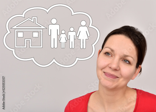 Smiling thoughtful woman with thought bubble thinking about her home and family