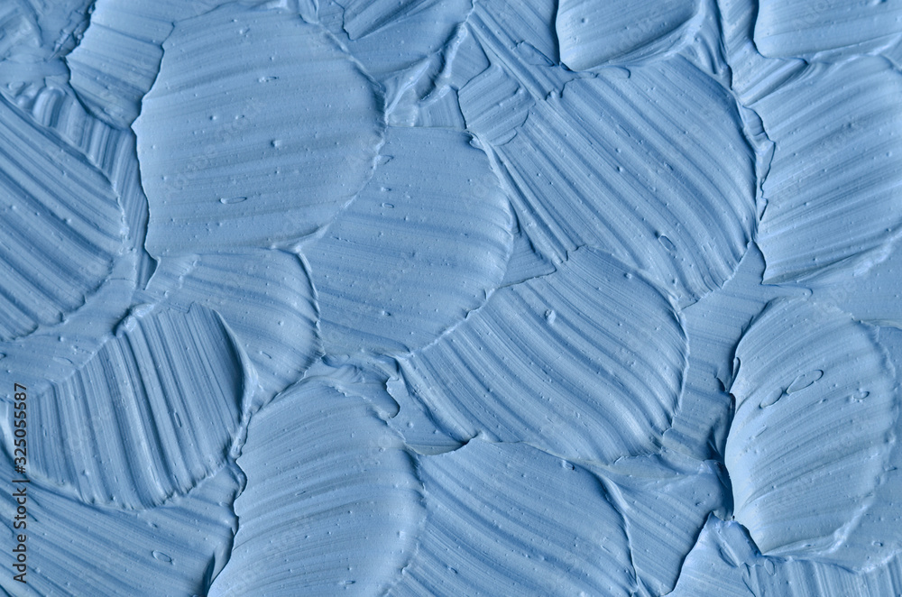 Obraz premium Light blue bentonite facial clay (mask, face cream, body wrap) texture close up, selective focus. Abstract background with brush strokes.