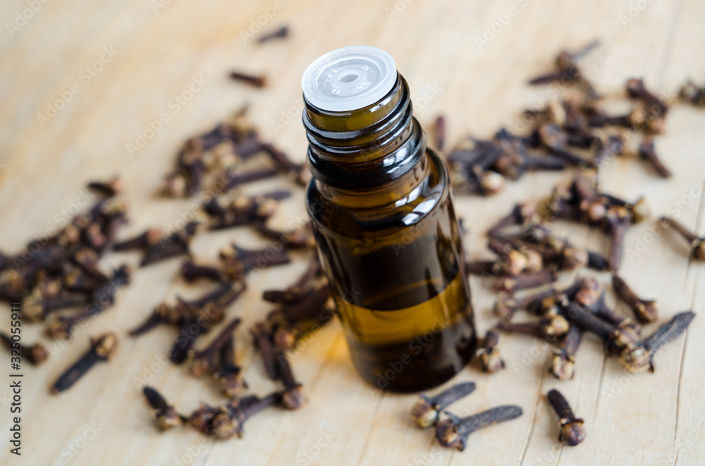Small bottle with essential clove oil. Aromatherapy, herbal medicine and spa ingredient. Small bottle with essential clove oil. Aromatherapy, herbal medicine and spa ingredient.