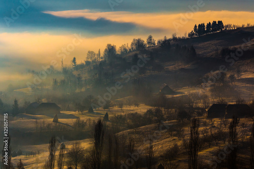 Beautiful misty rural landscape at sunrise in Romania