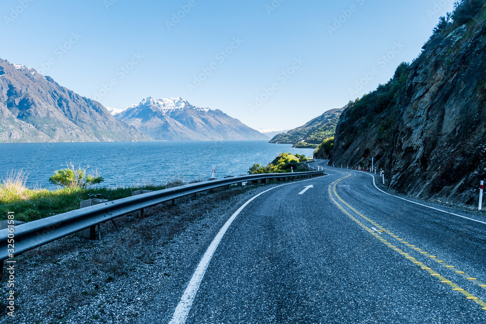 Winding road at lake and mountains New Zealand