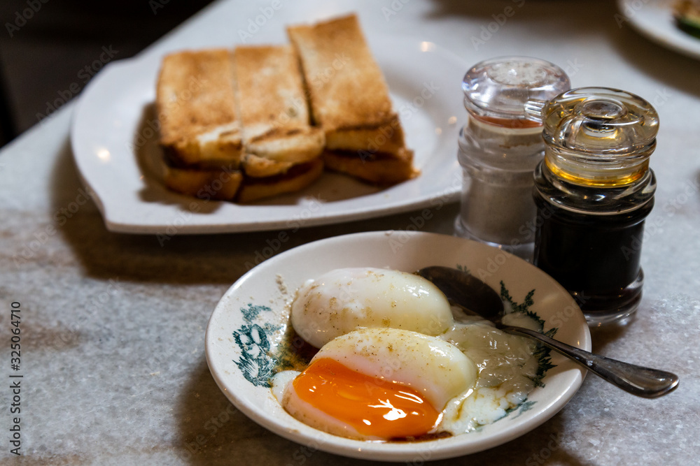 Half boiled eggs and toast bread, popular Chinese style breakfast in Malaysia Half boiled eggs and toast bread, popular Chinese style breakfast in Malaysia