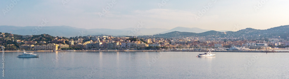 Panoramic view, aerial skyline of city Cannes, Mediterranean Sea with yachts, coastline, port morning at dawn in Cannes, Cote d'Azur, France