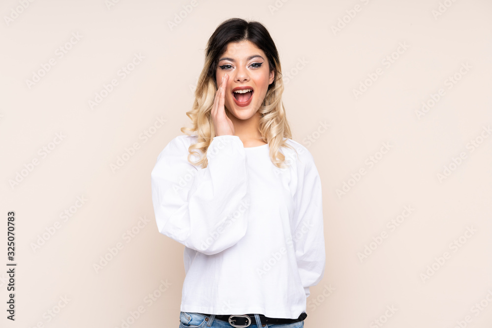 Teenager girl isolated on beige background with surprise and shocked facial expression Teenager girl isolated on beige background with surprise and shocked facial expression