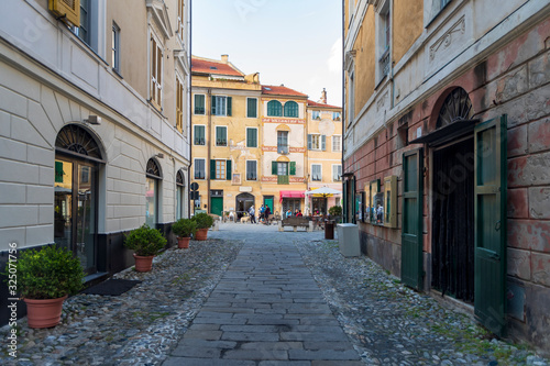 View along narrow street in the medieval village of Finalborgo, Liguria region, Italy
