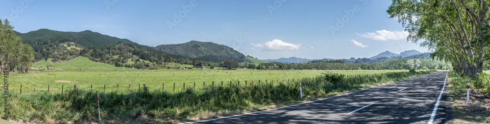 road and  green countryside landscape, near Hikuai, New Zealand