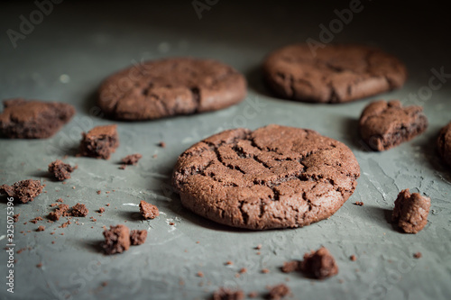 Close up of homemade chocolate cookie on gray concrete background. Selective focus. Shallow depth of field