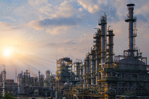 Manufacturing of petroleum industrial plant with sunset sky background, Gas distillation tower in petrochemical plant
