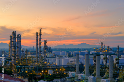 Factory of oil and gas refinery industrial plant with sunrise sky background, Pipeline of petrochemical industry, Smoke stacks of power plant