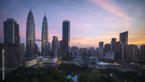 Kuala Lumpur, Malaysia - August 31, 2019: 4k time lapse of sunrise at Kuala Lumpur capital city centre photo