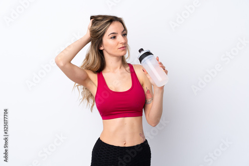 Young sport woman over isolated white background with sports water bottle