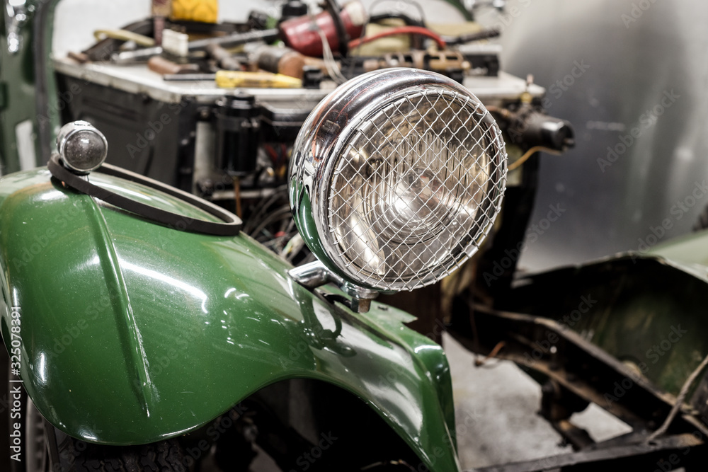 Classic car being restored to original condition in workshop