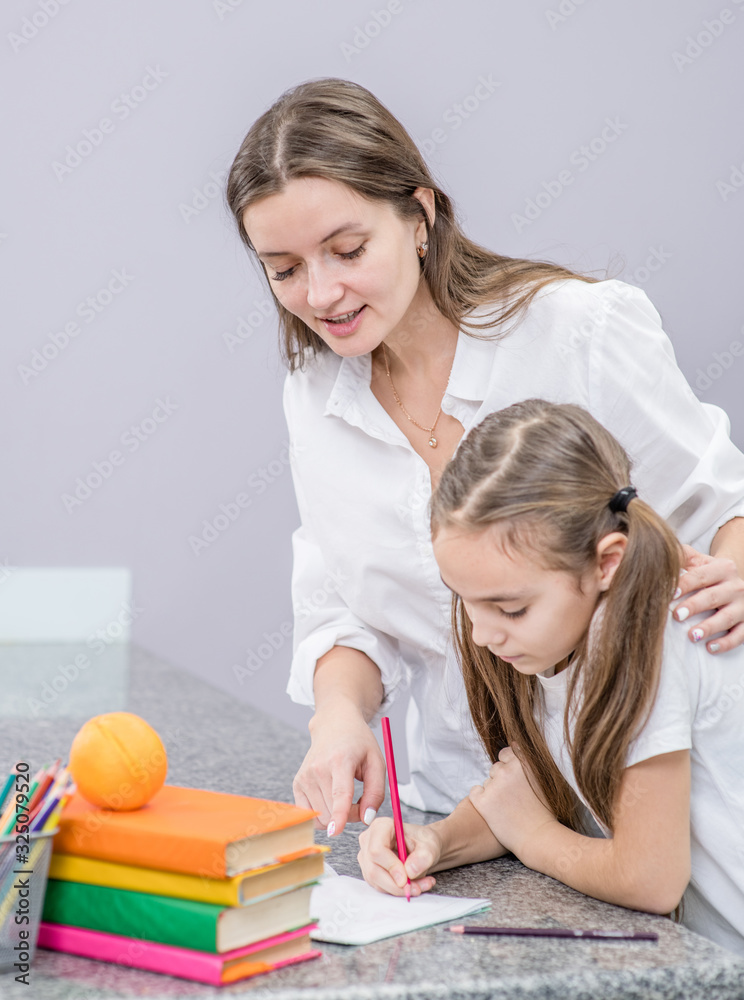 Mom checks her daughter's homework Mom checks her daughter's homework
