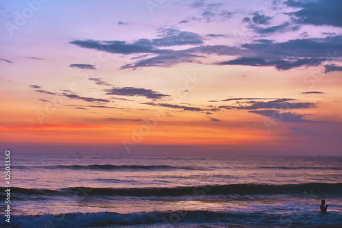 beautiful small waves with a reddish sky over the ocean