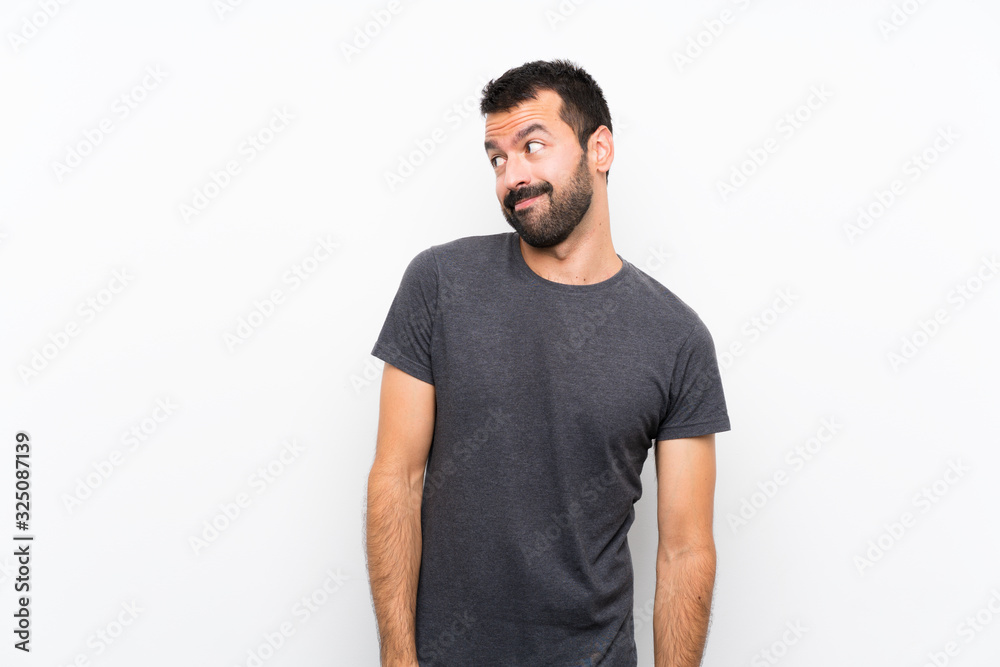 Young handsome man over isolated white background making doubts gesture looking side Young handsome man over isolated white background making doubts gesture looking side
