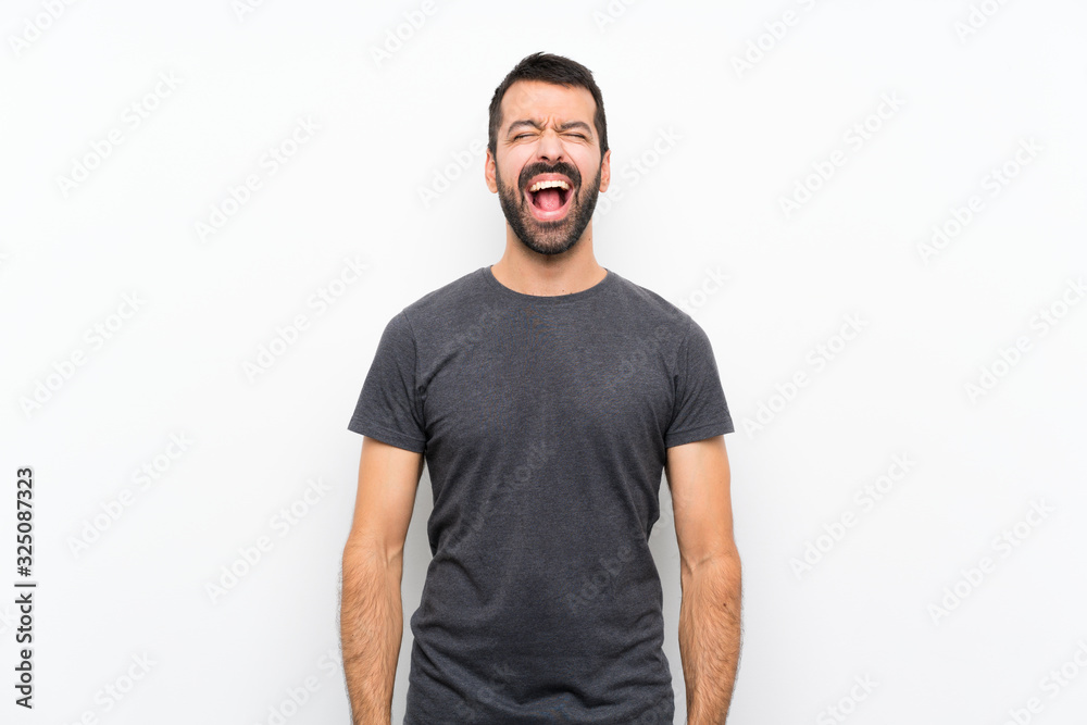 Young handsome man over isolated white background shouting to the front with mouth wide open