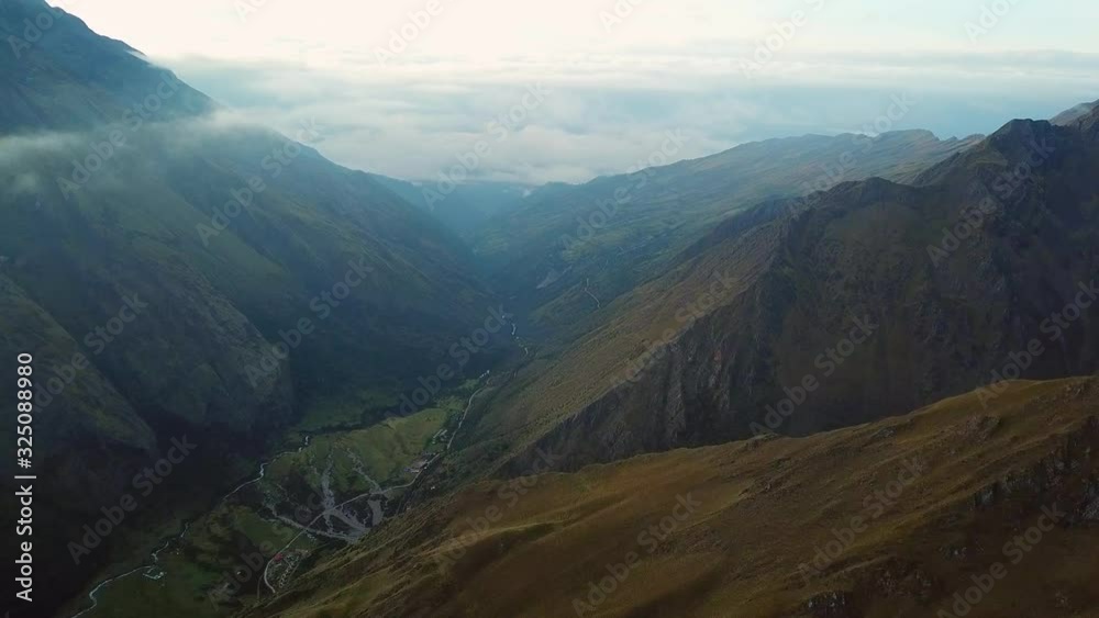 Aerial, drone shot over mountains, towards dark clouds in a valley, in Andes, Peru, South America Aerial, drone shot over mountains, towards dark clouds in a valley, in Andes, Peru, South America