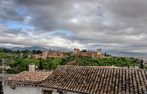 flawor of andalusia, view of the alhambra from the saint nicolas sightseein during a cloudy day granada, spain photo