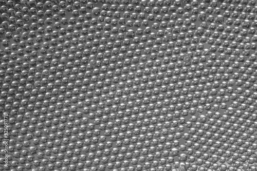 Small glass balls closeup as background. Black and white image.