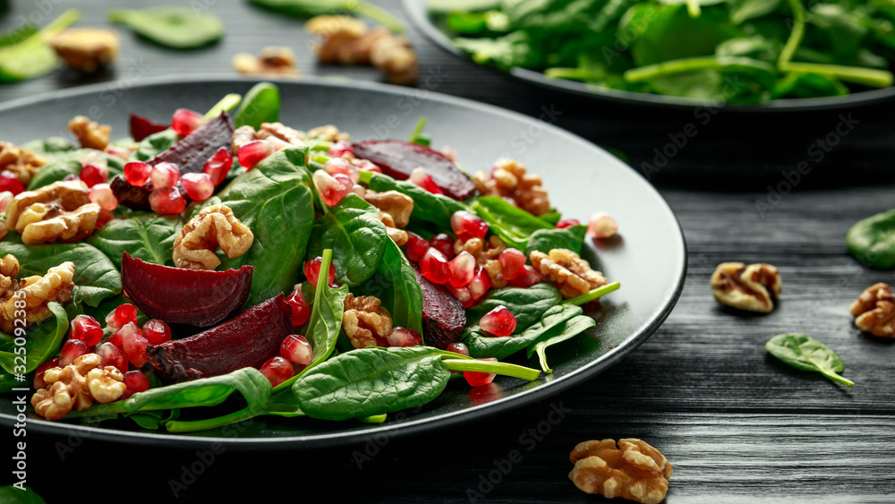 Healthy Beet Salad with fresh sweet baby spinach, pomegranate seeds and candy walnut. healthy Vegan vegetarian, plant based food