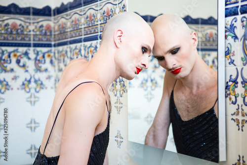 Person wearing makeup in front of a mirror
