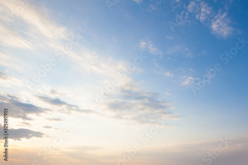 Blue sky clouds background. Beautiful landscape with clouds and orange sun on sky