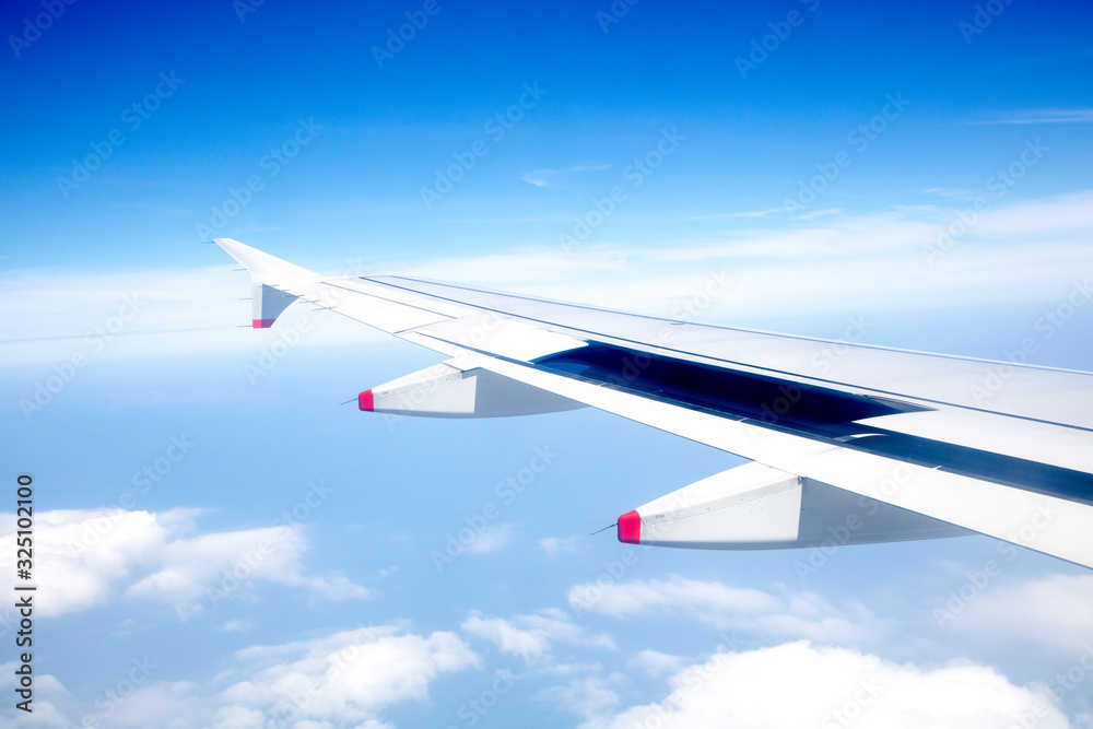 Clouds and sky as seen through window of an aircraft