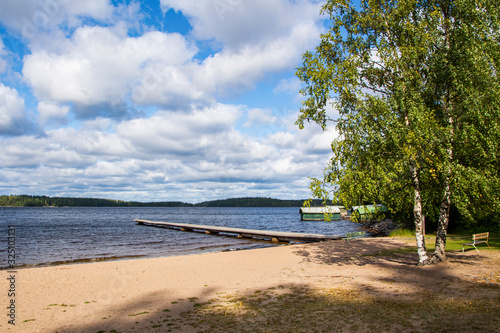 Fototapeta Naklejka Na Ścianę i Meble -  View to The Lake Saimaa and wooden swimming pier from Lempukka Beach, Imatra, Finland