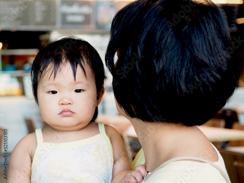 Close up cute asian infant baby girl and pretty asian woman with happy emotion.Concept is family mother and daughter.