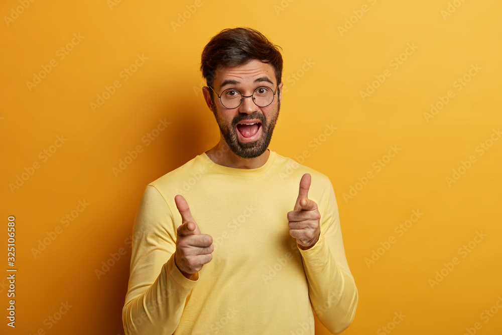 Positive delighted bearded man appealing to you, points fingers at camera, makes good choice, has funny joyful expression, chooses someone, shows its up to you gesture, picks potential client Positive delighted bearded man appealing to you, points fingers at camera, makes good choice, has funny joyful expression, chooses someone, shows its up to you gesture, picks potential client