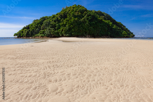 Tropical forest island at the end of paradise sand beach