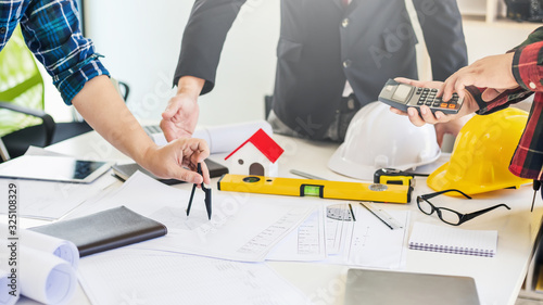 Businessman, construction project owner and engineer planning and meeting construction plan together.