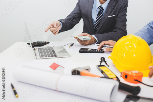 Businessman, construction project owner and engineer planning and meeting construction plan together.