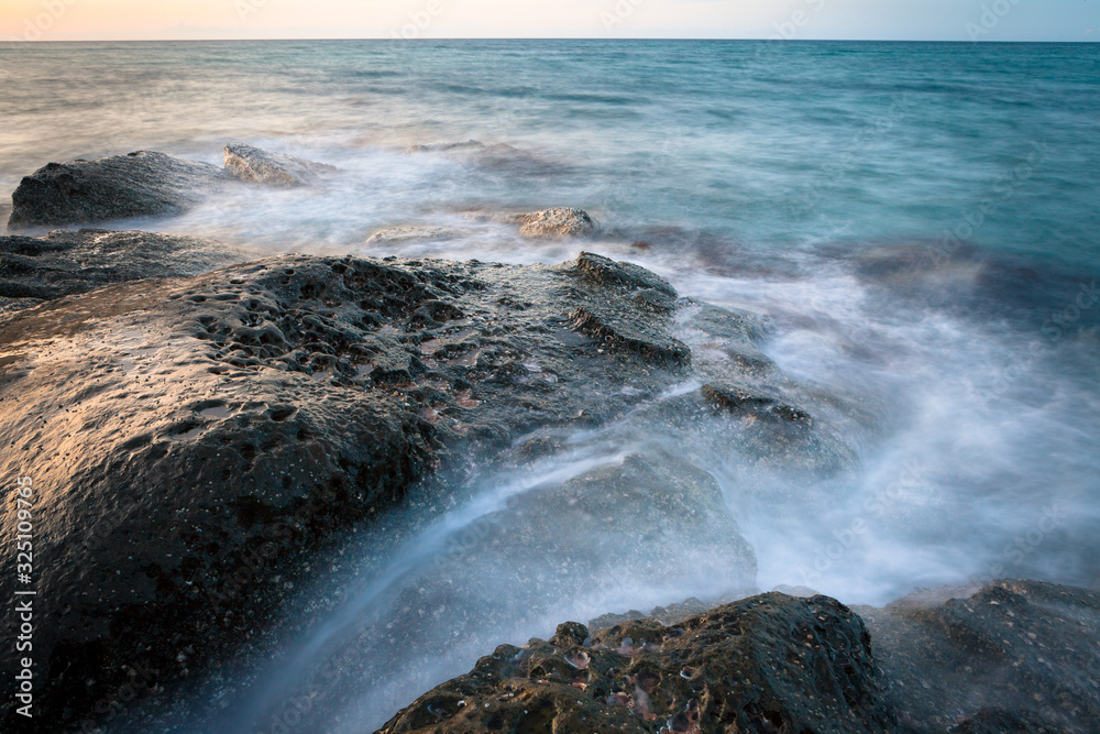 Waves and rocks shore long exposure Waves and rocks shore long exposure
