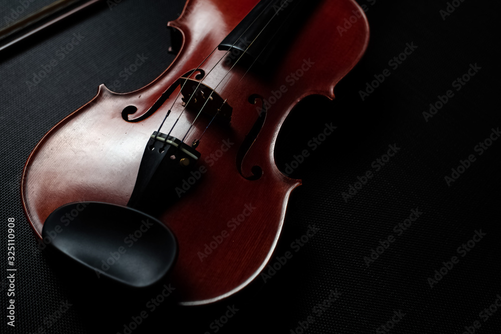 Fototapeta premium The wooden violin put on background,show front side of acoustic instrument