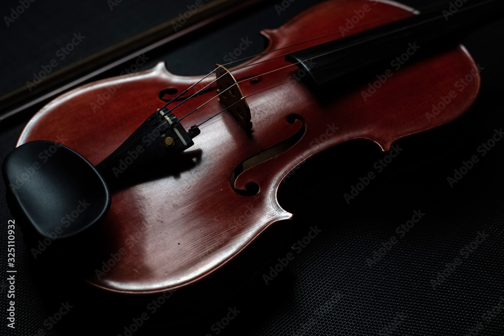 Fototapeta premium The wooden violin put on background,show front side of acoustic instrument