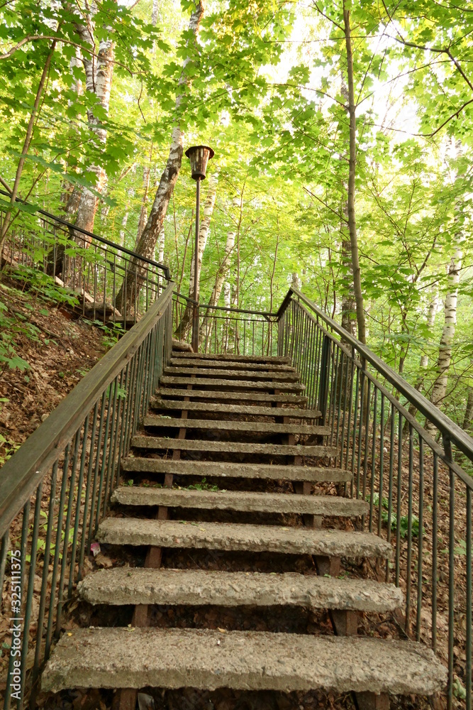 Old lantern on the forest stairs