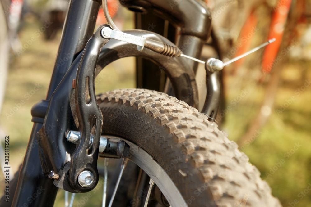 Rim brakes. Bicycle front wheel brake, Dual pivot brake caliper of bike. Rim brakes. Bicycle front wheel brake, Dual pivot brake caliper of bike.