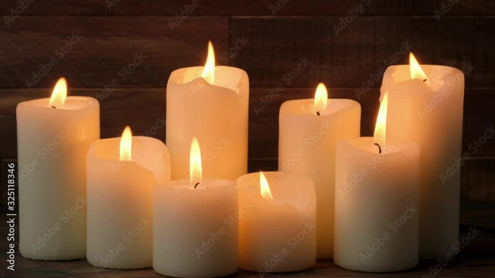 Close-up burning candles on wooden background Close-up burning candles on wooden background