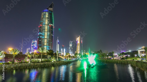 Music fountains in park with Kuwait City cityscape night timelapse hyperlapse