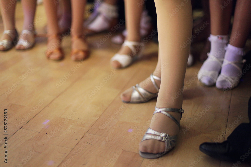 Children's legs in a ballroom dancing shoes ready to dance competition Children's legs in a ballroom dancing shoes ready to dance competition