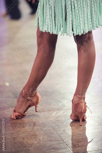 Beautiful legs of woman ballroom latin dancer in the movement